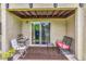 Covered patio featuring outdoor seating and sliding glass door with views of a serene landscape at 4215 E Bay Dr # 1706A, Clearwater, FL 33764