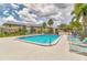 Community pool with lounge chairs and lush landscaping provides a relaxing oasis for residents at 4215 E Bay Dr # 1706A, Clearwater, FL 33764