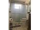 Bathroom featuring a tiled shower with glass door and modern fixtures at 4219 Gray Squirrel Ln, New Port Richey, FL 34653