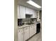 Well-lit kitchen featuring white cabinets, granite countertops, and stainless steel appliances at 4219 Gray Squirrel Ln, New Port Richey, FL 34653