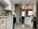 Well-equipped kitchen with white cabinets, granite countertops, stainless steel appliances, and modern fixtures at 4219 Gray Squirrel Ln, New Port Richey, FL 34653