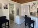 Bright kitchenette with charming coffee station, breakfast bar seating, and view to adjacent room at 4219 Gray Squirrel Ln, New Port Richey, FL 34653