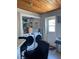 Convenient laundry area featuring a modern washer and dryer, wood ceilings, and storage shelves at 4219 Gray Squirrel Ln, New Port Richey, FL 34653