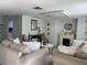 Inviting living room features neutral decor, a cozy fireplace, and plenty of seating at 4219 Gray Squirrel Ln, New Port Richey, FL 34653