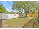 Backyard with swing set, slide and mature trees at 4613 Summerwind Ct, Plant City, FL 33566
