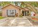 Charming single-story home with brick accents, a cozy porch, and colorful landscaping at 4613 Summerwind Ct, Plant City, FL 33566