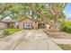 A charming single-story house with brick accents, a cozy front porch and a concrete driveway at 4613 Summerwind Ct, Plant City, FL 33566
