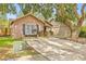 A charming single-story house with brick accents, a cozy front porch and a concrete driveway at 4613 Summerwind Ct, Plant City, FL 33566
