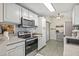 Modern kitchen equipped with stainless steel appliances and ample cabinet space at 4613 Summerwind Ct, Plant City, FL 33566