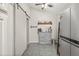 Bright kitchen with a rustic coffee bar, modern appliances, and a sliding barn door at 4613 Summerwind Ct, Plant City, FL 33566
