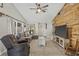 Comfortable living room with plush seating, TV, ceiling fan and cozy decor at 4613 Summerwind Ct, Plant City, FL 33566
