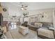 Bright living room with open floor plan, comfortable seating, ceiling fan and lots of natural light at 4613 Summerwind Ct, Plant City, FL 33566