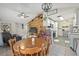Open-concept living space with wood accent wall, dining area, and kitchen at 4613 Summerwind Ct, Plant City, FL 33566