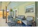 Cozy covered patio with contemporary outdoor seating and double door access to the interior at 4613 Summerwind Ct, Plant City, FL 33566