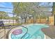 Inviting screened-in pool featuring clear water, and a play set in the fenced backyard at 4613 Summerwind Ct, Plant City, FL 33566