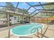 Wide angle shot of a bright and inviting screened-in pool and patio area with outdoor seating at 4613 Summerwind Ct, Plant City, FL 33566