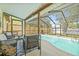 Inviting screened-in pool area with plenty of seating and lush landscaping at 4613 Summerwind Ct, Plant City, FL 33566