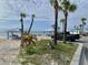 Picturesque beach featuring shaded picnic areas, palm trees, and convenient parking at 4712 Marine Pkwy # 203, New Port Richey, FL 34652