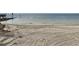 Sandy beach view with tide lines and a calm ocean horizon at 4712 Marine Pkwy # 203, New Port Richey, FL 34652