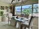Bright dining room with elegant table set and natural light at 4712 Marine Pkwy # 203, New Port Richey, FL 34652