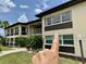 Beautiful condo building featuring large windows and manicured lawn at 4712 Marine Pkwy # 203, New Port Richey, FL 34652