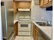 Efficient kitchen design with white appliances and tile backsplash at 4712 Marine Pkwy # 203, New Port Richey, FL 34652