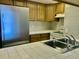 Well-maintained kitchen area featuring stainless steel refrigerator and sink at 4712 Marine Pkwy # 203, New Port Richey, FL 34652