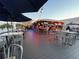 Vibrant outdoor bar and dining area with seating under shade at 4712 Marine Pkwy # 203, New Port Richey, FL 34652