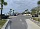 Large parking lot with palm trees and various vehicles, near a beach area at 4712 Marine Pkwy # 203, New Port Richey, FL 34652