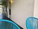 Inviting patio with bright blue chairs, offering a relaxing outdoor space for enjoying the surroundings at 4712 Marine Pkwy # 203, New Port Richey, FL 34652