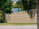 View of a serene street, partial view of the community pool, and natural beauty at 4712 Marine Pkwy # 203, New Port Richey, FL 34652