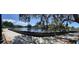 Scenic waterfront view with a beautiful canal, walkway, and lush trees at 4712 Marine Pkwy # 203, New Port Richey, FL 34652