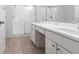 Bathroom features a double sink vanity, white cabinets, and a glass-enclosed shower at 5017 46Th W St, Bradenton, FL 34210