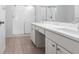 Bright bathroom featuring dual sinks, a shower with sliding-glass doors, and light-colored tile flooring at 5017 46Th W St, Bradenton, FL 34210