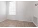 Bright bedroom featuring a blind-covered window, tile flooring, and neutral colored walls at 5017 46Th W St, Bradenton, FL 34210