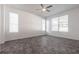 Bright bedroom features a ceiling fan, tiled floors, and multiple windows with natural lighting at 5017 46Th W St, Bradenton, FL 34210