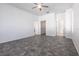 Bright bedroom featuring tile flooring, three blind-covered windows, neutral colored walls, ceiling fan, and closets at 5017 46Th W St, Bradenton, FL 34210