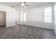 Bright bedroom featuring tile flooring, three blind-covered windows, neutral colored walls, and a ceiling fan at 5017 46Th W St, Bradenton, FL 34210