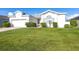 Charming single-story white home with a lush green lawn and mature landscaping at 5017 46Th W St, Bradenton, FL 34210