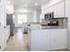 Bright kitchen features white cabinets and stainless steel appliances at 5017 46Th W St, Bradenton, FL 34210