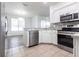 Modern kitchen with stainless steel appliances, granite countertops, and tiled flooring at 5017 46Th W St, Bradenton, FL 34210