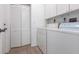 Convenient laundry room with washer, dryer, cabinets, and a door leading to the exterior at 5017 46Th W St, Bradenton, FL 34210