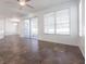 Open-concept living space with tile flooring, ceiling fan, and sliding glass doors at 5017 46Th W St, Bradenton, FL 34210
