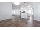 Open living area with tile flooring, white walls, and view of a modern kitchen at 5017 46Th W St, Bradenton, FL 34210