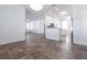 Bright, open-concept living space featuring tile flooring, recessed lighting, and a kitchen in the background at 5017 46Th W St, Bradenton, FL 34210