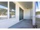 Enclosed patio includes white walls, white lattice and a sliding glass door at 5017 46Th W St, Bradenton, FL 34210
