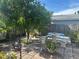 Backyard featuring brick pavers, mature shade trees, lush landscaping, and an outdoor seating area at 5106 Gateway Dr, Tampa, FL 33615