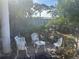 Landscaped backyard featuring seating area, brick pavers, lush plants, and trees at 5106 Gateway Dr, Tampa, FL 33615