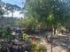 Backyard featuring brick pavers, lush landscaping, and mature shade trees at 5106 Gateway Dr, Tampa, FL 33615