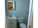Bathroom featuring a sink, mirror, toilet, and tiled walls at 5106 Gateway Dr, Tampa, FL 33615